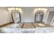 Double vanity bathroom with granite countertops and rectangular mirrors at 542 Little Vine Church Rd, Villa Rica, GA 30180