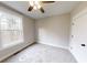Spacious bedroom with a large window and carpet flooring at 542 Little Vine Church Rd, Villa Rica, GA 30180