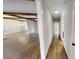 Long hallway with hardwood floors and exposed wooden beams at 542 Little Vine Church Rd, Villa Rica, GA 30180