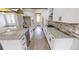 White kitchen with granite countertops, stainless steel appliances, and hardwood floors at 542 Little Vine Church Rd, Villa Rica, GA 30180