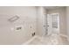 Laundry room with built-in shelving and tile floor at 542 Little Vine Church Rd, Villa Rica, GA 30180