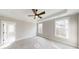 Spacious bedroom with carpet, ceiling fan, and large windows at 542 Little Vine Church Rd, Villa Rica, GA 30180