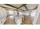 Open concept kitchen and living area with hardwood floors and kitchen island at 542 Little Vine Church Rd, Villa Rica, GA 30180