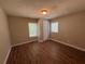 Well-lit bedroom featuring wood-look floors and ample natural light at 6862 Old Beulah Rd, Lithia Springs, GA 30122