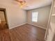 Bright bedroom with wood-look floors, ceiling fan, and built-in shelving at 6862 Old Beulah Rd, Lithia Springs, GA 30122