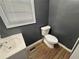 Small bathroom with toilet, sink, and vinyl flooring at 6862 Old Beulah Rd, Lithia Springs, GA 30122