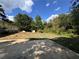 Large backyard with a cleared area and surrounding trees at 6862 Old Beulah Rd, Lithia Springs, GA 30122