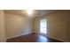 Spacious bedroom with large window and dark brown laminate flooring at 1967 Singer Way, Lithonia, GA 30058