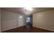 Living room with dark brown laminate flooring and an entrance at 1967 Singer Way, Lithonia, GA 30058