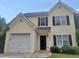 Charming two-story home with attached garage, front yard, and black shutters at 7015 Setters Way, Lithonia, GA 30038