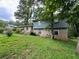 Brick and wood-sided house with a large front yard at 612 Mincey Woods Ct, Stone Mountain, GA 30087