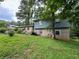 Brick and wood-sided house with a large front yard at 612 Mincey Woods Ct, Stone Mountain, GA 30087