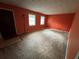 Living room with orange walls and carpeted floor at 612 Mincey Woods Ct, Stone Mountain, GA 30087