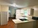 Galley kitchen with white cabinets and laminate flooring at 1468 Dwayne Ct, Lithonia, GA 30058