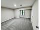 Bright bedroom with grey carpet and a large window at 5432 Post Road Pass, Stone Mountain, GA 30088