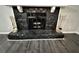 Stone fireplace with black glass doors and brass andirons at 5432 Post Road Pass, Stone Mountain, GA 30088