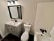 Updated bathroom features a vanity, toilet, and bathtub at 5432 Post Road Pass, Stone Mountain, GA 30088
