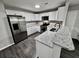 Modern kitchen with stainless steel appliances and granite counters at 5432 Post Road Pass, Stone Mountain, GA 30088