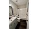 Updated bathroom with grey vanity and dark floor at 5432 Post Road Pass, Stone Mountain, GA 30088