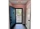 Inviting entryway with teal door and tile floor at 5432 Post Road Pass, Stone Mountain, GA 30088