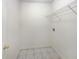 Bright laundry room with tile flooring and ample shelving at 5233 Walnut Ct, Lithonia, GA 30038