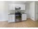 Bright kitchen with stainless steel appliances and white cabinets at 5233 Walnut Ct, Lithonia, GA 30038