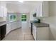 Modern kitchen with white cabinets, gray countertops and black appliances at 5233 Walnut Ct, Lithonia, GA 30038