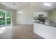 Kitchen with island, white cabinets and access to backyard at 5233 Walnut Ct, Lithonia, GA 30038
