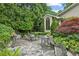 Stone patio with lush landscaping and metal seating at 2726 Mabry Ne Rd, Atlanta, GA 30319