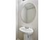 Small bathroom with pedestal sink and oval mirror at 3583 Rock Ridge Dr, Rex, GA 30273