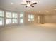 Spacious finished basement with multiple windows, carpet, and ceiling fan at 249 Chadwyck Ln, Canton, GA 30115