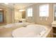 Large bathroom with a garden tub and a large mirror at 249 Chadwyck Ln, Canton, GA 30115