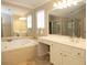 Bathroom with double vanities, a large soaking tub, and a separate shower at 249 Chadwyck Ln, Canton, GA 30115
