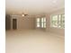 Finished basement with large windows, neutral carpeting, and ceiling fan at 249 Chadwyck Ln, Canton, GA 30115
