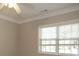 Well-lit bedroom with neutral walls, window, and ceiling fan at 249 Chadwyck Ln, Canton, GA 30115