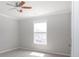 Bright bedroom with neutral walls and carpeting, featuring a ceiling fan at 249 Chadwyck Ln, Canton, GA 30115