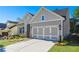 Two-story house with gray siding, three-car garage, and well-manicured lawn at 2013 Ripple Park Bnd, Canton, GA 30114