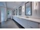 Luxurious bathroom with double vanities, quartz countertops, and modern lighting at 2883 W Roxboro Ne Rd, Atlanta, GA 30324