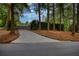 Long driveway leading to a gated estate, lined with mature trees at 2883 W Roxboro Ne Rd, Atlanta, GA 30324