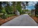 Long driveway leading to a luxurious home with gated entry at 2883 W Roxboro Ne Rd, Atlanta, GA 30324