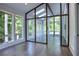 Bright sunroom with hardwood floors and walls of windows at 2883 W Roxboro Ne Rd, Atlanta, GA 30324