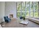 Spacious living room with stone fireplace, hardwood floors, and large windows at 2883 W Roxboro Ne Rd, Atlanta, GA 30324