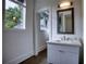 Modern bathroom with white vanity and dark wood floors at 2883 W Roxboro Ne Rd, Atlanta, GA 30324