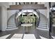 Two grand staircases flank a striking stone sculpture in the foyer at 2883 W Roxboro Ne Rd, Atlanta, GA 30324