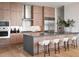 Gourmet kitchen with wood cabinetry, marble backsplash and island at 40 12Th Ne St # 1005, Atlanta, GA 30309
