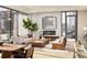 Spacious living room with hardwood floors, large windows, fireplace, and city view at 40 12Th Ne St # 1005, Atlanta, GA 30309