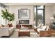 Living room features hardwood floors, a fireplace and large windows with city views at 40 12Th Ne St # 1005, Atlanta, GA 30309