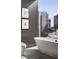 Bathroom with freestanding bathtub, city view, and dark gray walls at 40 12Th Ne St # 1005, Atlanta, GA 30309