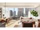 Open concept living and dining area with hardwood floors and floor to ceiling windows at 40 12Th Ne St # 1005, Atlanta, GA 30309