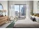 Spacious bedroom with large windows offering city views at 40 12Th Ne St # 1005, Atlanta, GA 30309